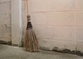 Coconut broom stick on the floor and empty right space for text. Natural materials and safely decomposed