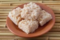 Coconut candy cocada on brown plate Royalty Free Stock Photo