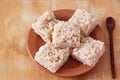 Coconut candy cocada on brown plate Royalty Free Stock Photo