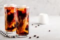 Coconut chai iced coffee with ice cubes in tall glasses Royalty Free Stock Photo