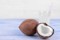 coconut and coconut milk on a blue wooden table and on a white background with a place for writing