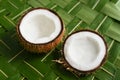 Coconut cut in half Kerala India. on green coconut palm leaf