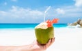 Coconut drink in palm hand on a tropical beach La Digue Seychelles Islands Royalty Free Stock Photo