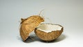 Coconut, exotic fruits, two halves of the fruit in the shell, white background, selective focus, selective light, close-up Royalty Free Stock Photo