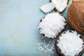 Coconut flakes in a shell on a blue background. top view with copy space Royalty Free Stock Photo