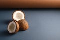 Coconut fruits on brown and blue grey folded paper background, abstract food tropical concept Royalty Free Stock Photo
