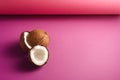Coconut fruits on vibrant pink purple folded paper background, abstract food tropical concept