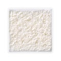 Coconut grains in square bowl on white background