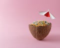 Coconut half with colorful sprinkles on pink background. Minimal food concept Royalty Free Stock Photo