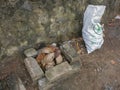 Coconut husks in the fireplace. Preparing for meat grilling. Primitive grill in Indonesia. Bricks, stones, wire mesh.