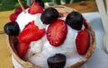 coconut ice-cream in coconut with strawberries and chocolate chips as topping