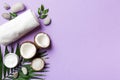 Coconut with jars of coconut oil and cosmetic cream on colored background. Top view. Free space for your text. Natural Royalty Free Stock Photo