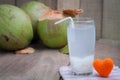 Coconut juice and group of coconut on wood floor. Royalty Free Stock Photo