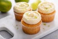 Coconut and key lime cupcakes on serving board Royalty Free Stock Photo