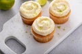 Coconut and key lime cupcakes on serving board Royalty Free Stock Photo