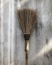 Coconut leaf broom on concrete background Royalty Free Stock Photo