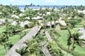 Coconut leaves thatched huts with blue ocean backdrop