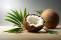 Coconut with leaves on wooden table, close-up