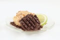A Coconut Macaroon with Dark Chocolate and a Piece of Lime