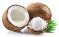 Coconut milk in cracked coconut fruit and coconut shreds on white background Royalty Free Stock Photo