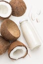 Coconut milk in glass and bowl. Coconut milk in bowl. Halfs fresh coconut