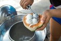 Coconut milk ice cream scooped into coconut shell