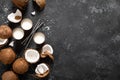 Coconut milk, whole and cracked coconuts on black background Royalty Free Stock Photo