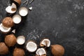 Coconut milk, whole and cracked coconuts on black background Royalty Free Stock Photo