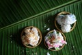 coconut muchkins, Sticky morsels, Rice flour mixed with toddy palm and shredded coconut Thai dessert on the green coconut leaf