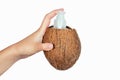 Coconut oil bottle and cap in a hand on white isolate Royalty Free Stock Photo