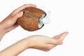 Coconut oil bottle and cap in a hand on white isolate Royalty Free Stock Photo