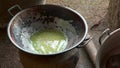 Coconut oil cooking instant hot method, at home. Heating and cooking coconut milk solution for oil extract. Female hands separate