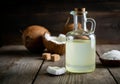 Coconut oil in a glass bottle with fresh coconuts and sea salt Royalty Free Stock Photo