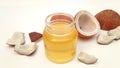 Coconut oil in a jar with coconuts zooming out over white background. Coconut closeup. skin care