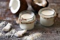 Coconut oil in a jar. Coconut halves.