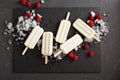 Coconut popsicles with raspberries on black background Royalty Free Stock Photo