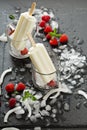 Coconut popsicles with raspberries on black background Royalty Free Stock Photo