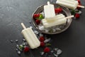 Coconut popsicles with raspberries on black background Royalty Free Stock Photo