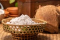 Coconut powder of a coconut in basket inside kitchen for making coconut milk