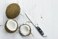 Coconut pulp fresh tropical brown white organic coconut milk knife on wooden white background