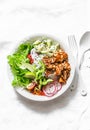 Coconut rice, grilled salmon and vegetables buddha bowl. Healthy lunch - rice, red fish, salad, avocado, radish, tomatoes on a lig Royalty Free Stock Photo