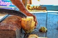 Coconut Seller. Close up of man cutting a coconut with a big Indian knife. Sale of coconuts. Indian street market,coconut cutting