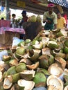 Coconut seller cutting coconut