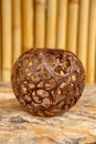 Coconut shell carving. Handicraft of indigenous people in Bali, Indonesia. Shelve with balinese souvenirs - ornamental shell for