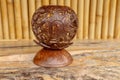 Coconut shell carving. Handicraft of indigenous people in Bali, Indonesia. Shelve with balinese souvenirs - ornamental shell for