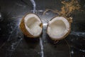 coconut split in half on a kitchen countertop Royalty Free Stock Photo