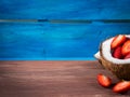 Coconut and strawberries on bright blue background Royalty Free Stock Photo