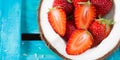 Coconut and strawberries on bright blue Royalty Free Stock Photo