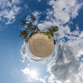 coconut trees in jungle in Indian tropic village on sea shore on little planet in blue sky, transformation of spherical 360 Royalty Free Stock Photo