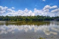 Coconut trees line and Cloud Reflections Mirror Image in River Royalty Free Stock Photo